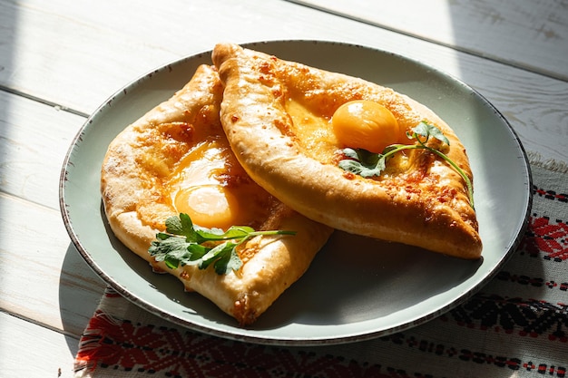 Two Adjarian khachapuri in traditional classic Georgian style