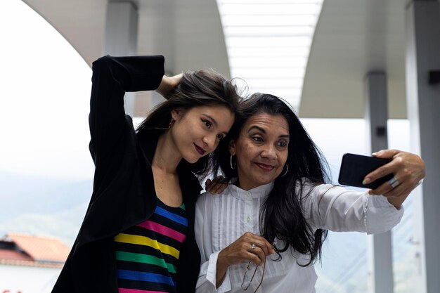 Two adult Latin American women mother and daughter on vacation with positive attitude