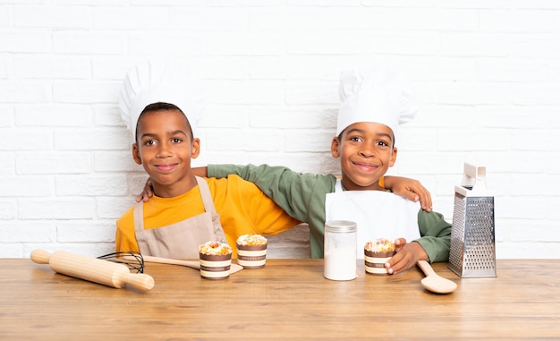 Two African American brothers kids dressed as chef