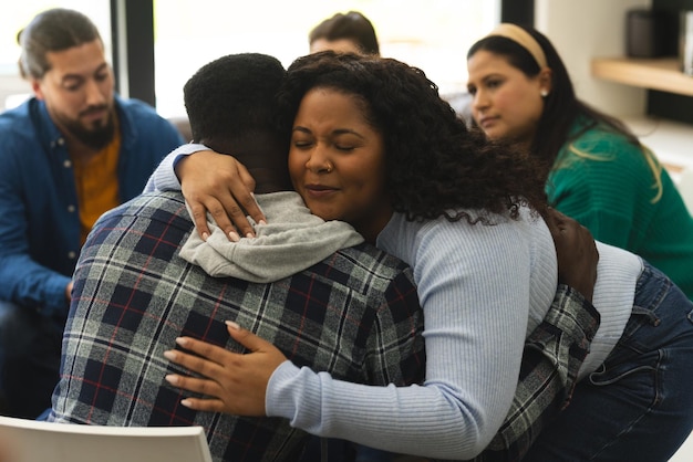 Photo two african american male and female friends hugging on therapy session