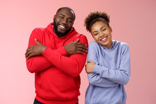 Two african american man woman couple feel comfortable warm together embracing each other cuddling happily tilting head look cute express love strong healthy relationship, smiling delighted
