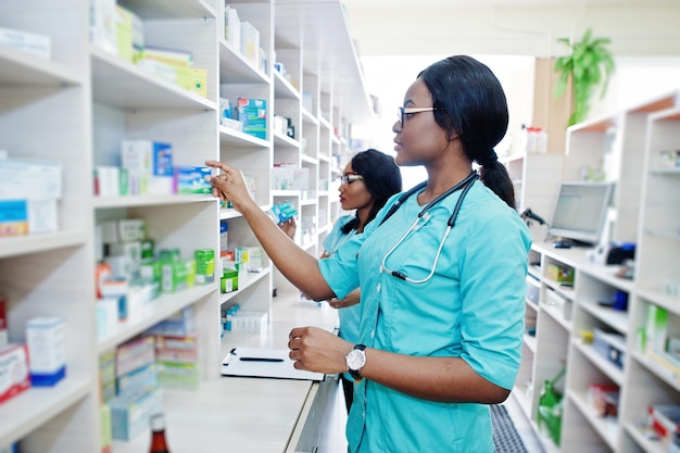 Two african american pharmacist working in drugstore at hospital pharmacy African healthcare