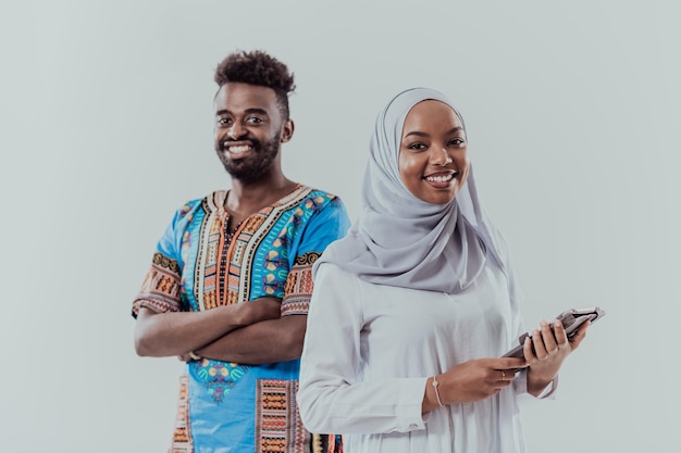 Two African American students with traditional clothes and modern models stand isolated on a white background. High quality photo