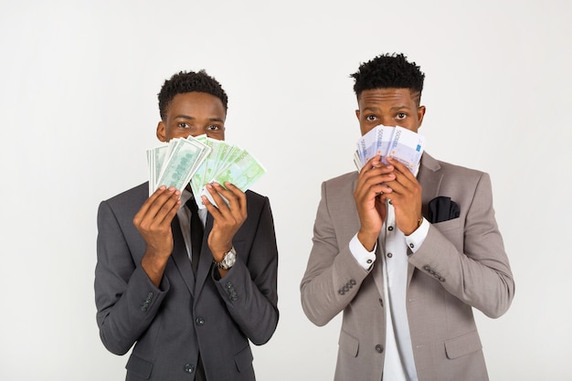 two african men in suits with euro money