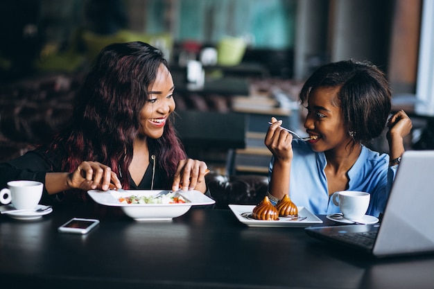 Two afro american women in a cafe at lunch