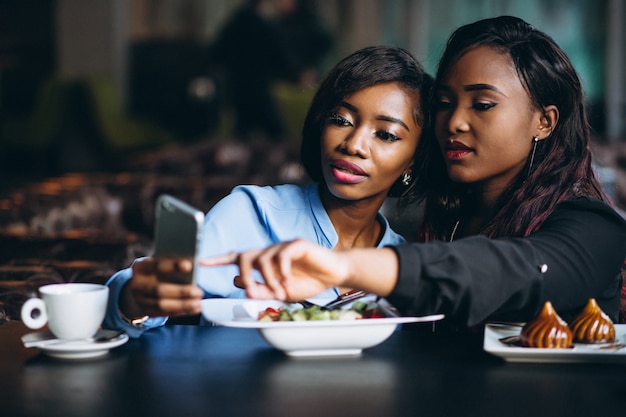 Two afro american women in a cafe at lunch