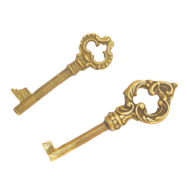 Photo two antique golden skeleton keys  isolated on white background