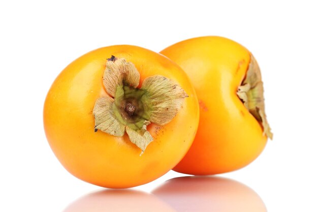 Two appetizing persimmons isolated on white