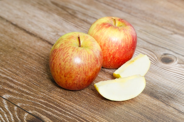 Two apples on a wood table with top view