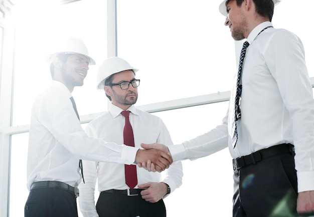 Two architects shaking hands after a meeting in officeconcept of cooperation