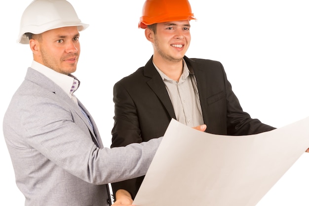 Two architects standing discussing a blueprint