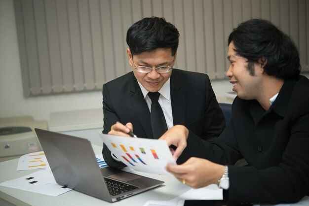 Two asian businessmen discuss about business of companyTwo people are talking about work stress and more serious