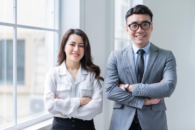 Two Asian businesspeople working at office