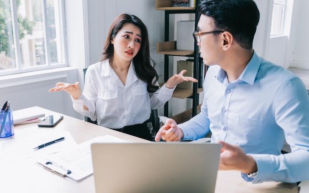 two asian businesspeople working at office