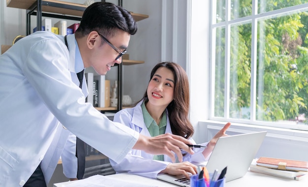 Two Asian doctors working together