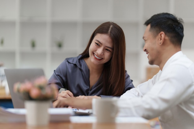 Two asian fund manager brainstorming new business project finance investment concept