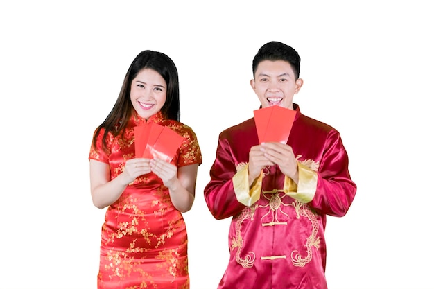 Two Asian people holding their angpaos happily