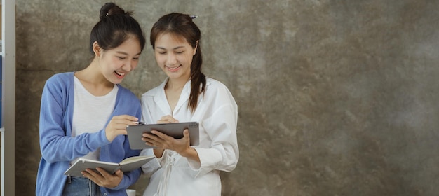 Two asian women chatting business women conversing in a
conference room young entrepreneurs run and run a startup young and
energetic group run the company startup company concept