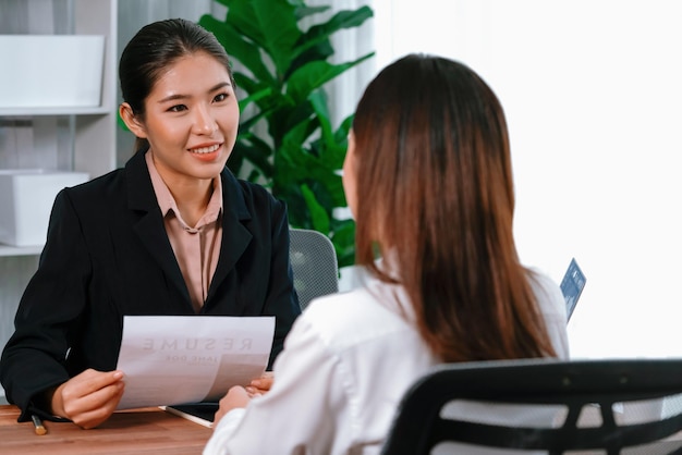 Photo two asian women conduct job interview in office enthusiastic