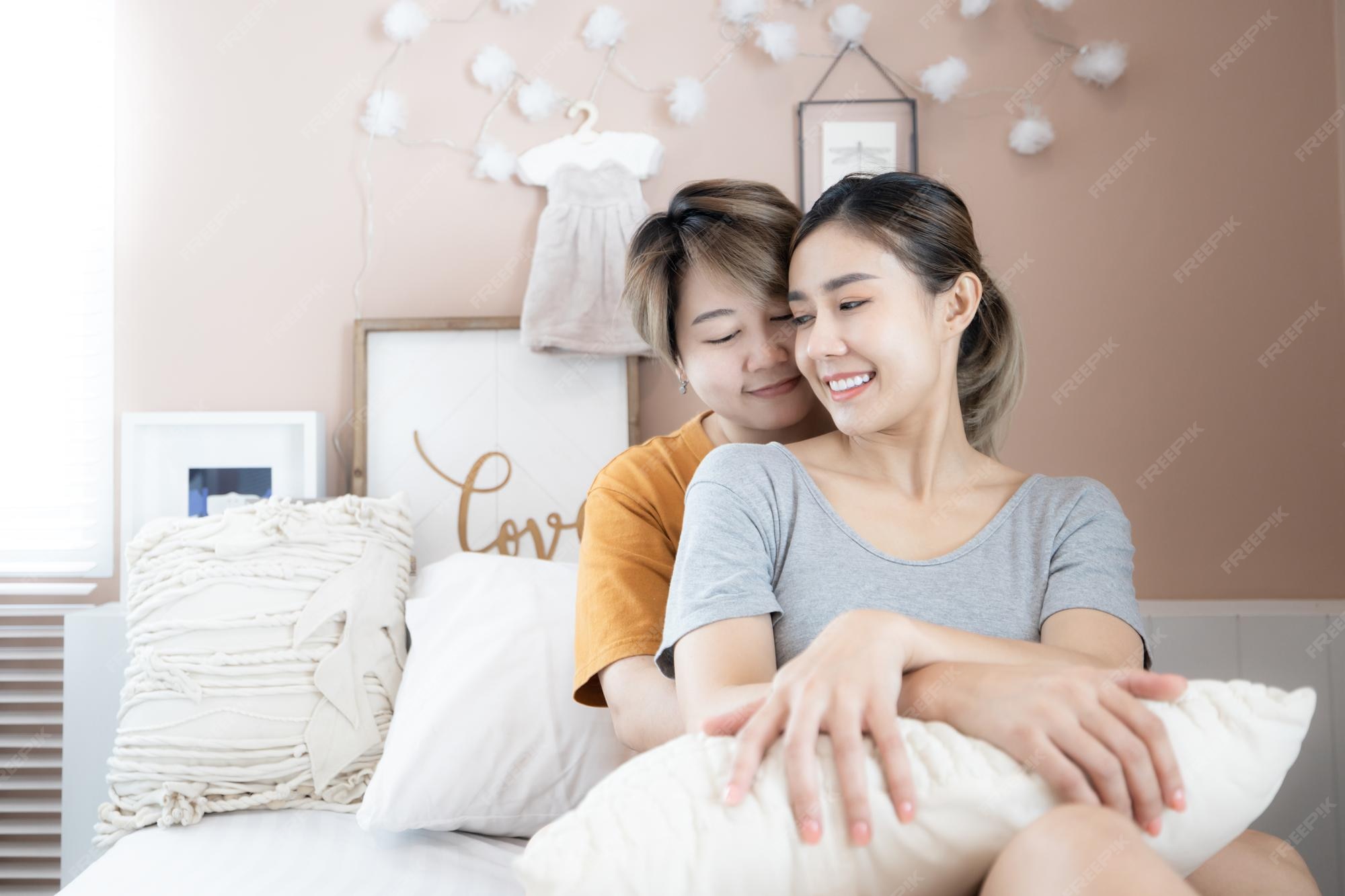 two asian women lgbtq lesbian homosexual lesbian couples lying bed looking together smile relax home asian woman lgbtqlgbtlgbtq love white bed head together 35024 1526