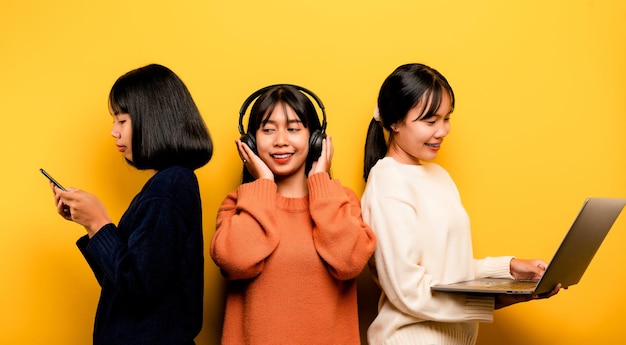 Two Asian women working on laptop and phone at the same time Two of them were communicating online