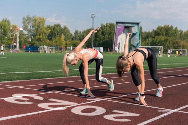 Two athlete young woman runnner on the start of  year