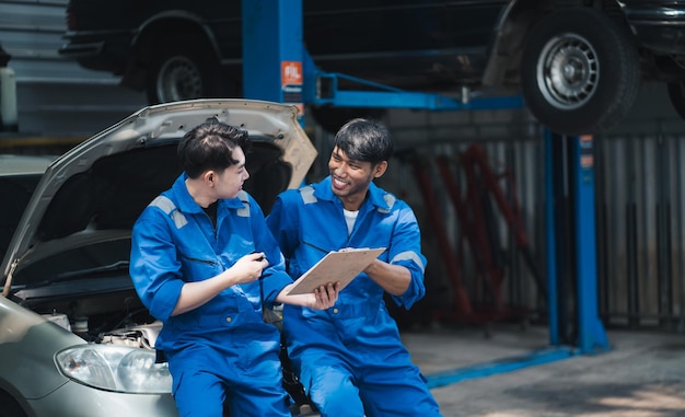 写真 修理工場で車診断ツールを使用する 2 人の自動車整備士