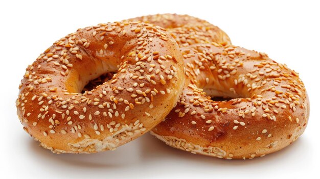 two bagels with sesame seeds are on a white surface