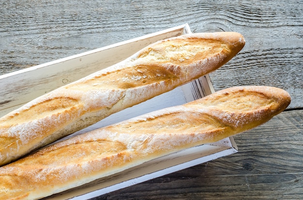 Two baguettes on wooden tray