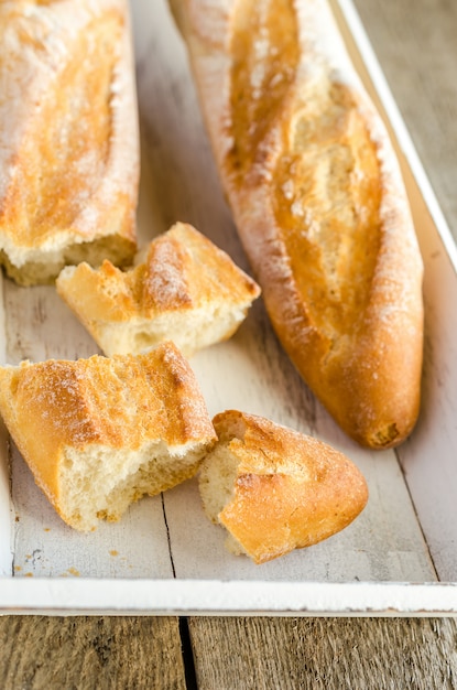 Two baguettes on the wooden tray