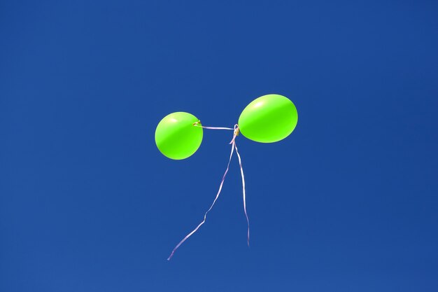 Two balloon against a blue sky. Holiday Decorations