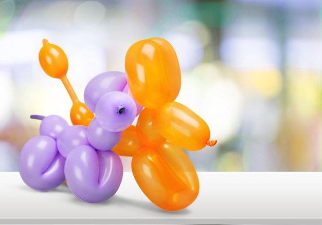 Two balloons in shape of animals on background