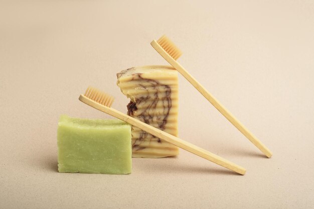 Two bamboo toothbrushes and two bars of handmade soap