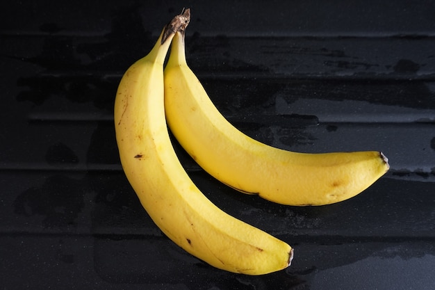 Two bananas isolated on black backgrou