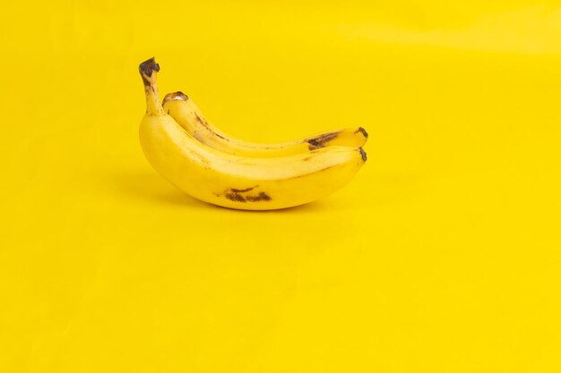 Two bananas on yellow background