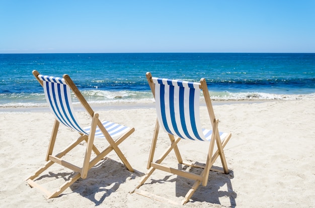 Two beach chairs near the ocean