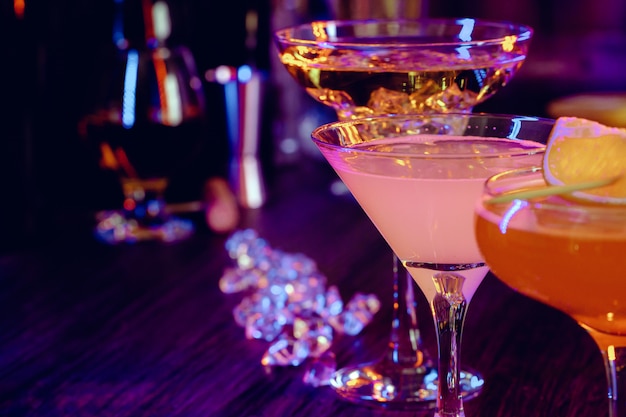 Two beautiful cocktails served on a wooden bar counter