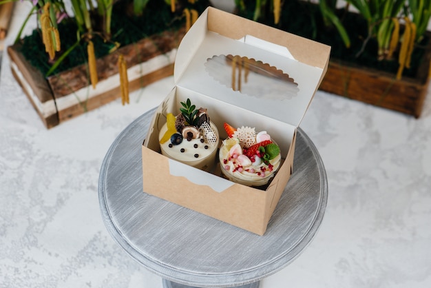 Two beautiful and delicious trifle cakes close-up on a light background in a gift box. Dessert, healthy food.