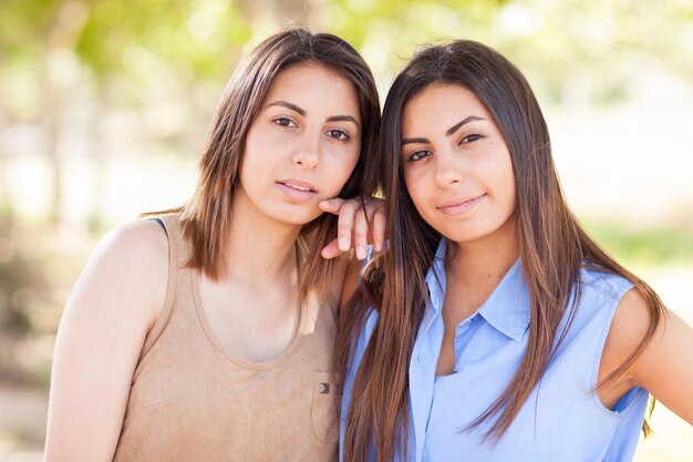 Two Beautiful Ethnic Twin Sisters Portrait Outdoors