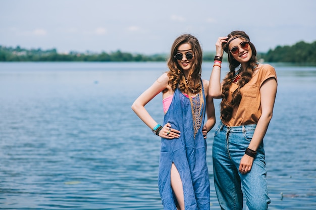 two beautiful girl friends on the dock