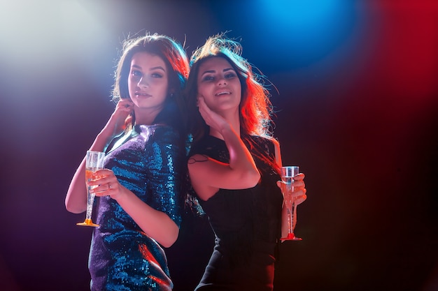 Two beautiful girls dancing at the party