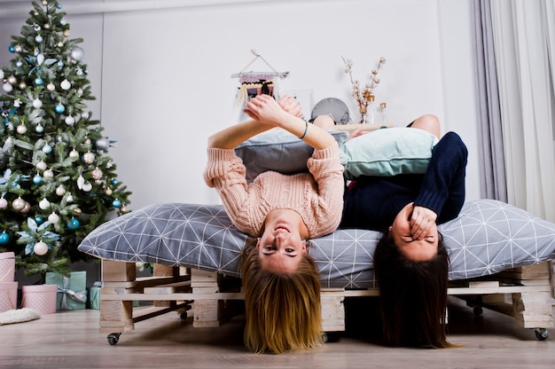 Two beautiful girls friends wear in warm sweater and leg warmers