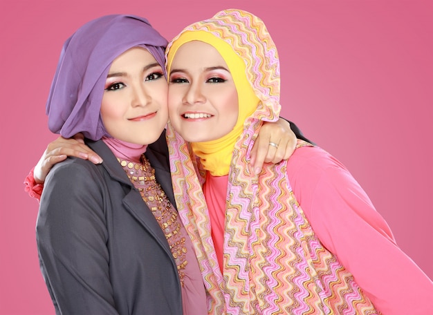 Two beautiful moslem woman having fun together