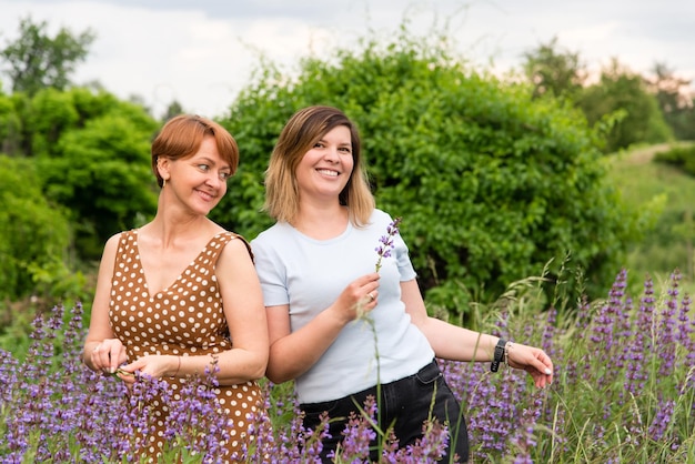 Two beautiful women are having fun in the garden. Married couple, sisters, friends.