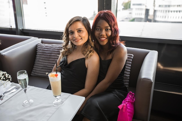 two beautiful women with makeup on a holiday in a restaurant with drinks