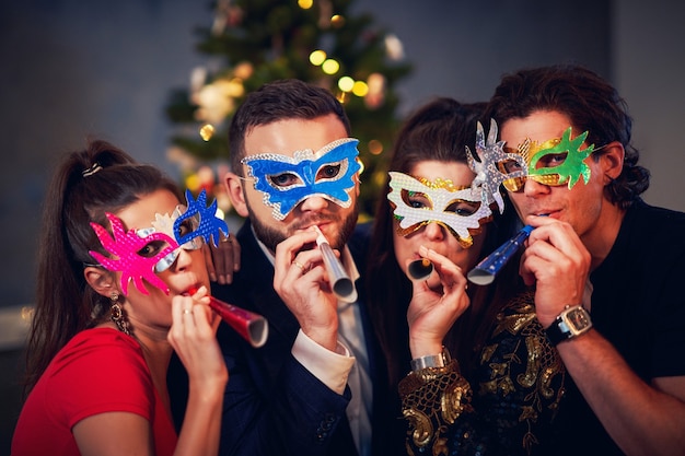 Two beautiful young couples having fun at New Year's Eve Party