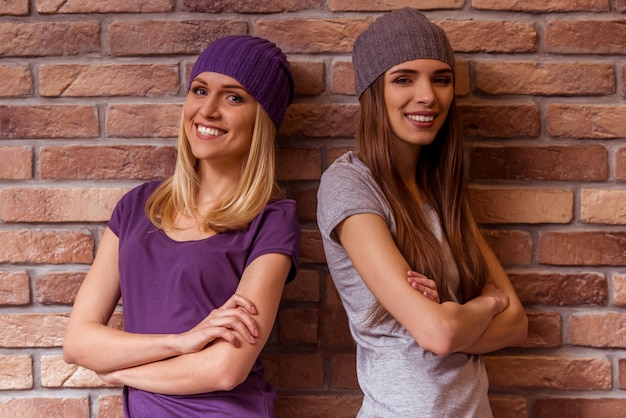 Two beautiful young girls are smiling.