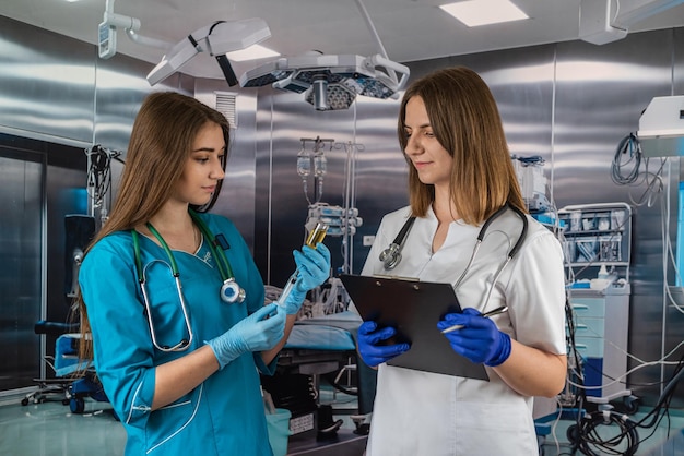 Two beautiful young nurses are in the operating room