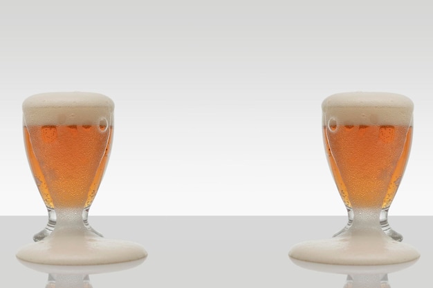 Two beer glasses filled with foam spilling down the side and room for text at the bottom