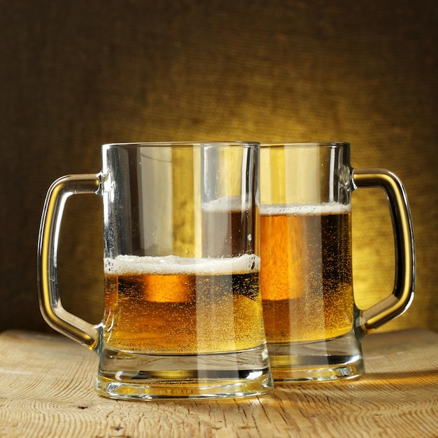 Two beer mugs on wooden table